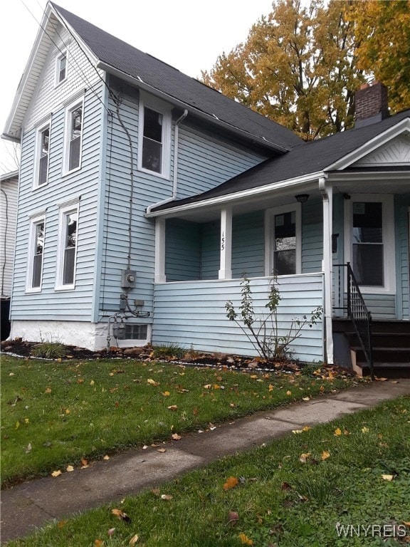 view of home's exterior featuring covered porch, central AC, and a lawn