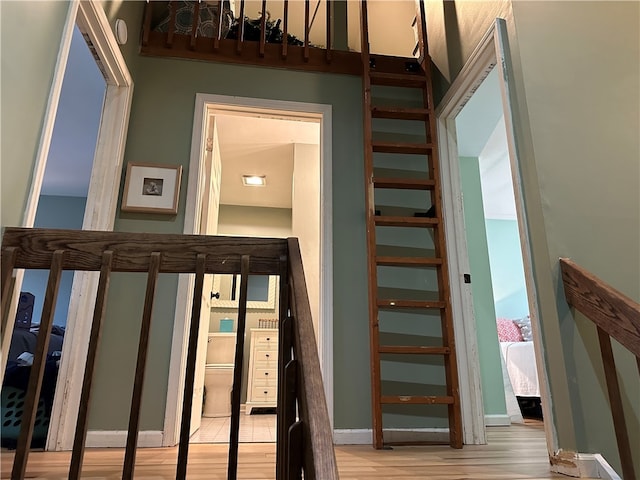 staircase with wood-type flooring