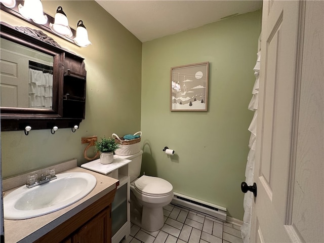 bathroom featuring tile patterned flooring, vanity, toilet, and baseboard heating