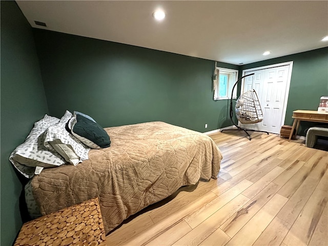 bedroom featuring light hardwood / wood-style floors and a closet