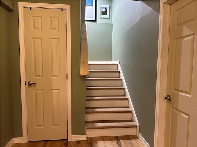 staircase featuring wood-type flooring