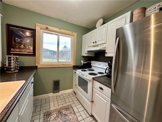 kitchen featuring sink, light tile patterned floors, white cabinetry, white electric stove, and stainless steel refrigerator