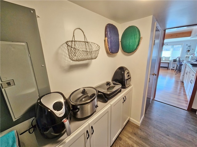 kitchen with dark hardwood / wood-style flooring and white cabinets