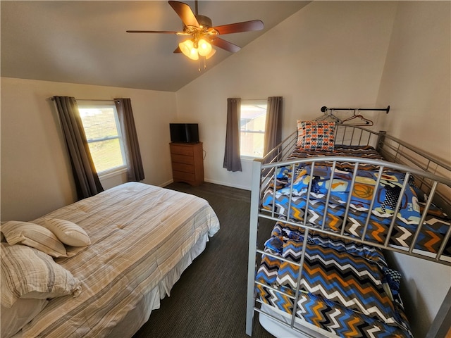 bedroom with dark colored carpet, ceiling fan, and lofted ceiling