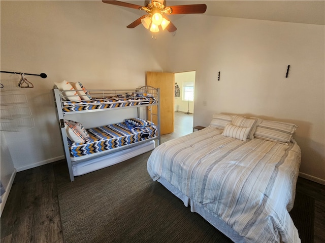 bedroom featuring dark hardwood / wood-style floors, ceiling fan, and lofted ceiling