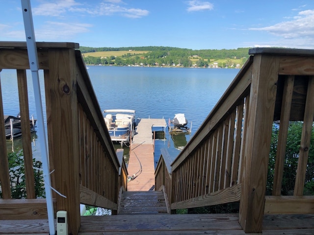 exterior space featuring a water view and a dock