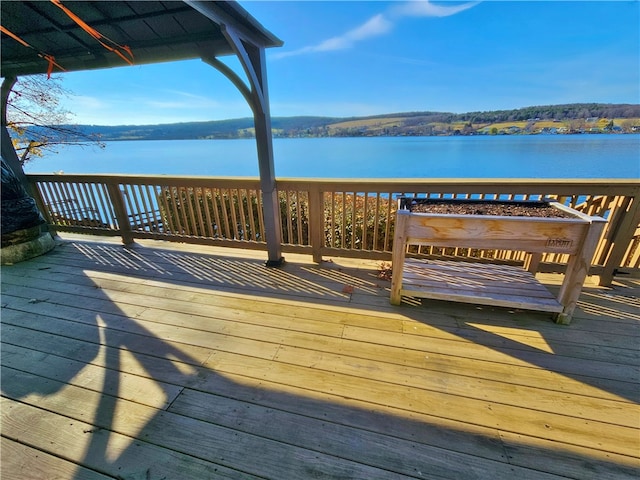 wooden terrace featuring a water view