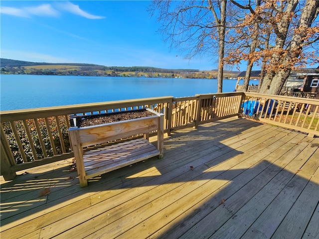 wooden terrace featuring a water view