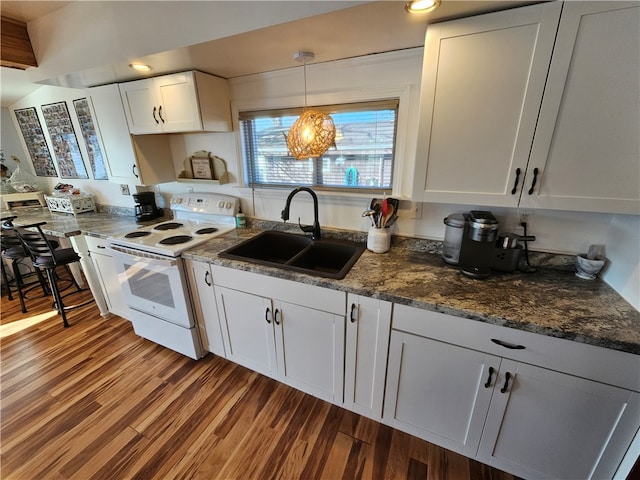 kitchen with white electric range oven, sink, decorative light fixtures, hardwood / wood-style flooring, and white cabinetry