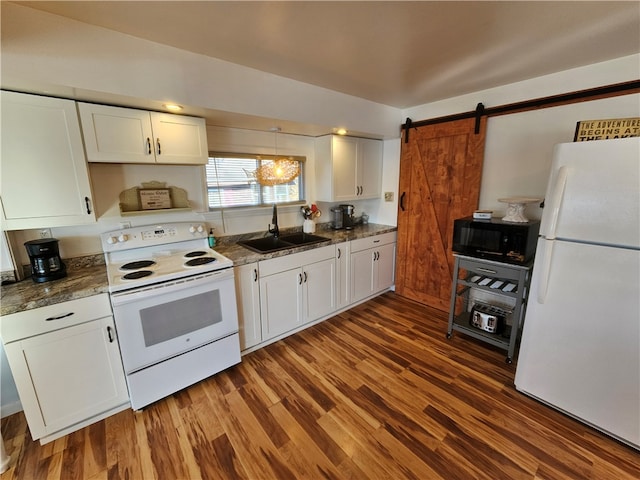 kitchen with white cabinets, dark hardwood / wood-style floors, a barn door, and white appliances