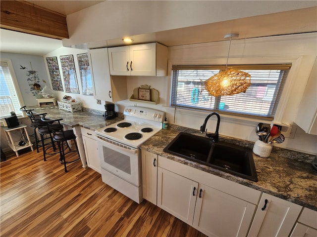 kitchen featuring sink, hanging light fixtures, white electric range oven, hardwood / wood-style floors, and white cabinets