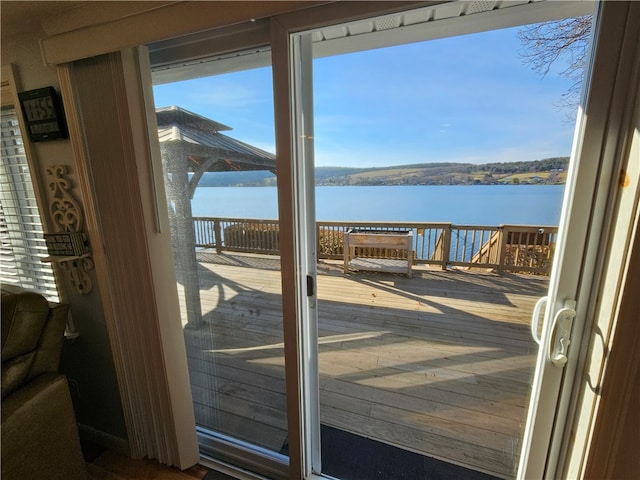 doorway featuring a water view and wood-type flooring