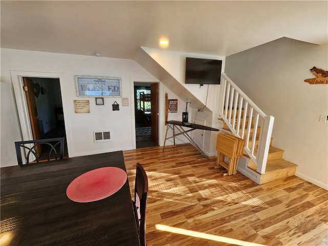 dining space with wood-type flooring