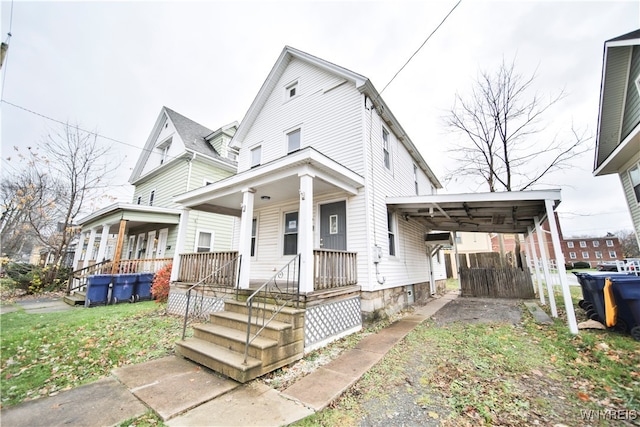 view of front of property featuring covered porch and a carport