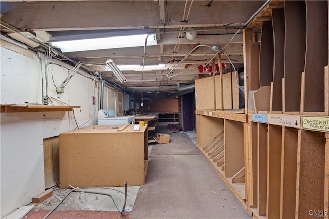 basement with electric panel and washer / clothes dryer