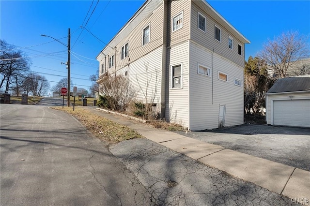 view of side of home with an outbuilding and a garage