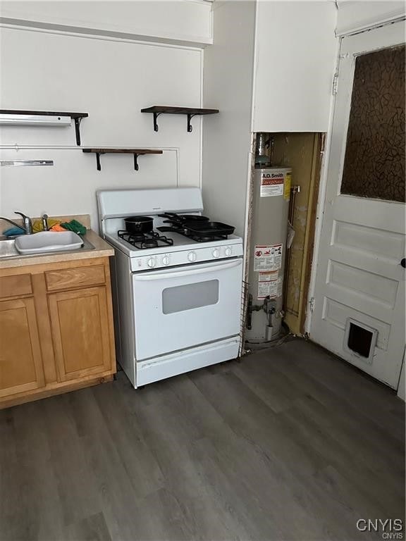 kitchen with dark wood-type flooring, water heater, sink, and white range with gas stovetop