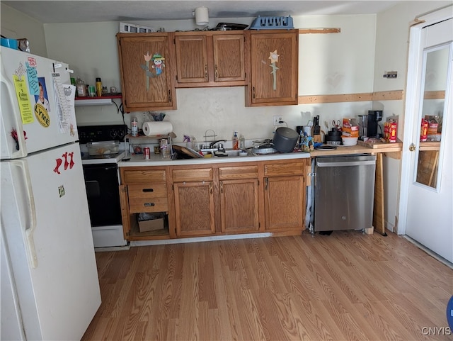 kitchen featuring sink, light hardwood / wood-style floors, and white appliances