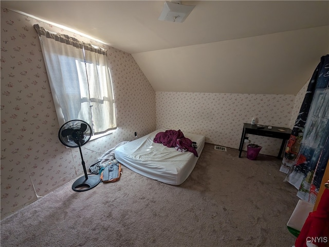 interior space featuring carpet flooring and vaulted ceiling