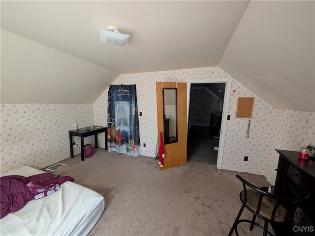 bonus room with lofted ceiling and light carpet