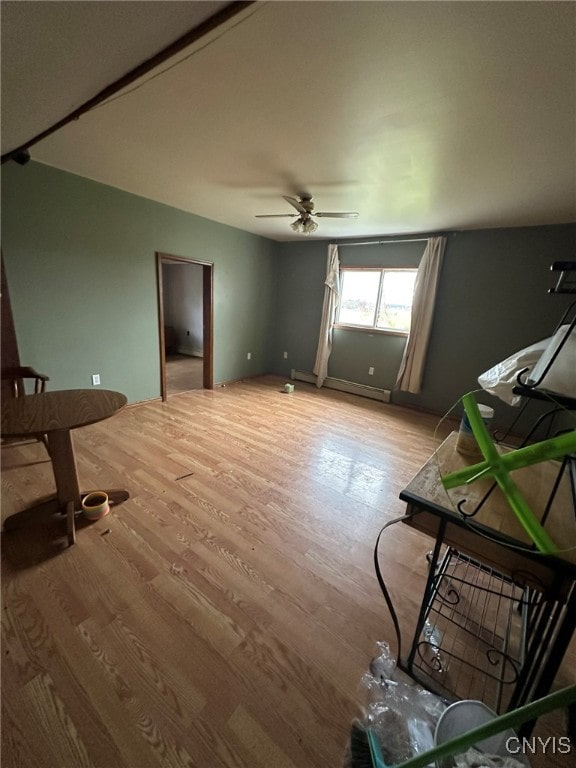 interior space with ceiling fan, light hardwood / wood-style flooring, and a baseboard radiator