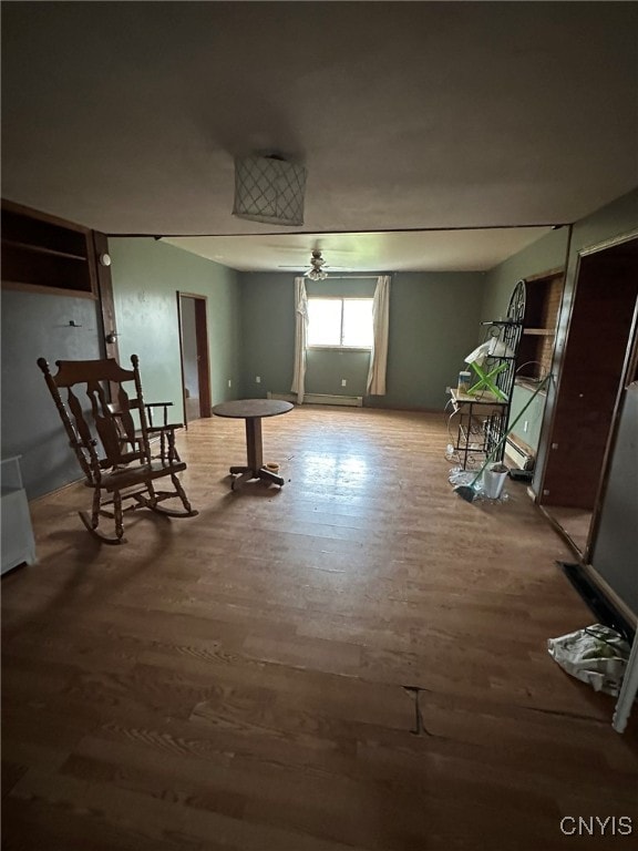 interior space with ceiling fan and wood-type flooring