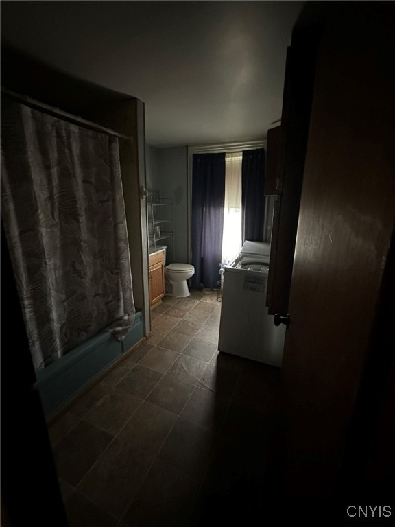 bathroom featuring vanity, curtained shower, and toilet