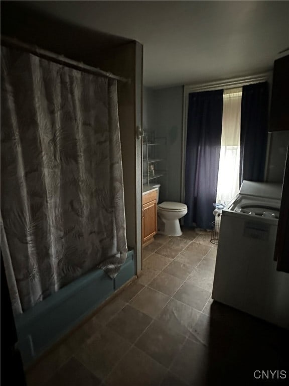 bathroom with tile patterned flooring, vanity, and toilet