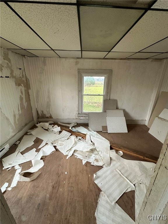 misc room featuring a paneled ceiling and wood-type flooring