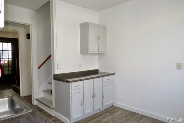 kitchen with white cabinets and light hardwood / wood-style floors