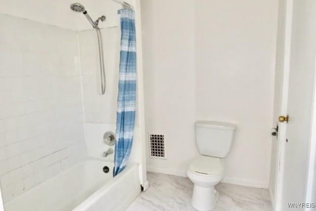 bathroom with shower / bath combo and toilet