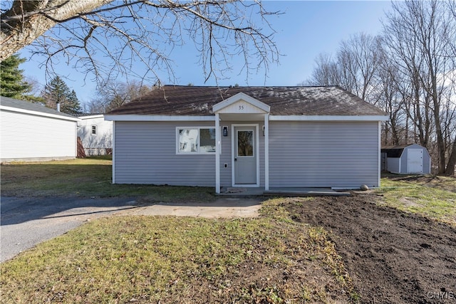 ranch-style house with a front yard and a storage unit