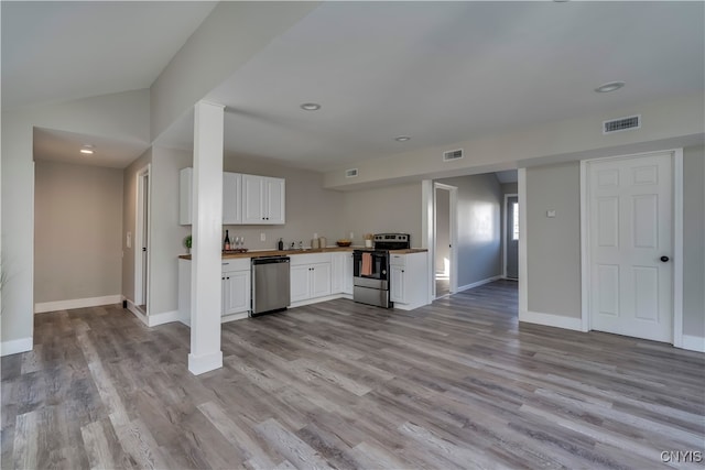 kitchen featuring white cabinets, stainless steel appliances, and light hardwood / wood-style floors