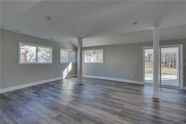 empty room with wood-type flooring and a wealth of natural light