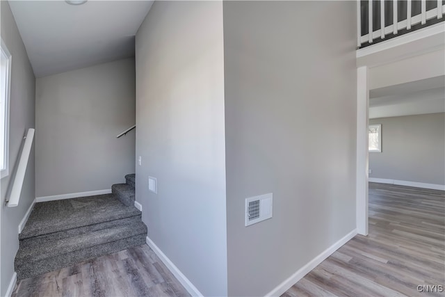 stairs featuring hardwood / wood-style floors