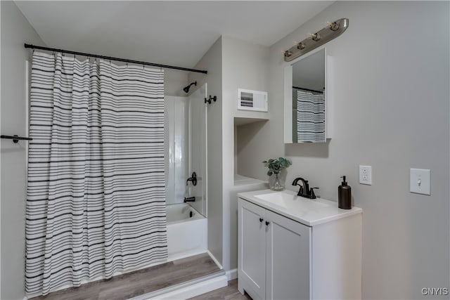 bathroom featuring hardwood / wood-style floors, vanity, and shower / tub combo with curtain