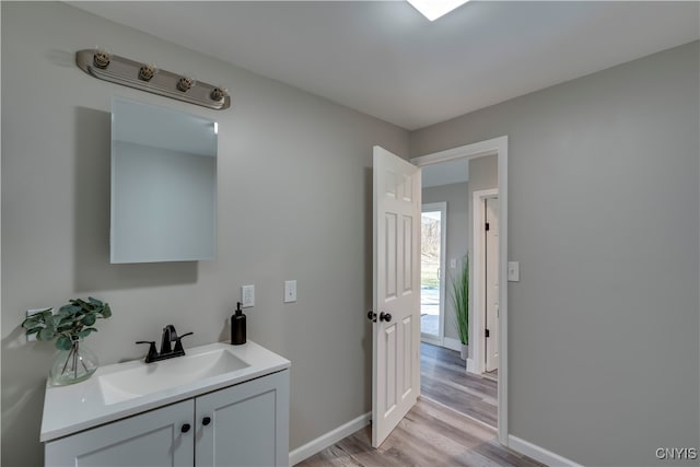 bathroom featuring hardwood / wood-style flooring and vanity