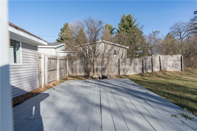 wooden terrace featuring a yard