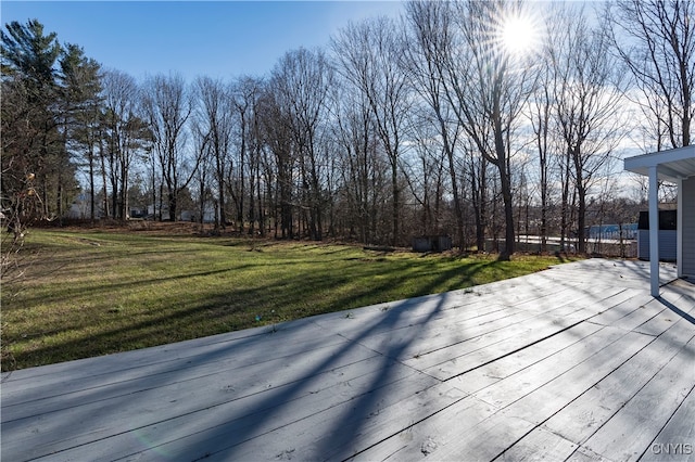 wooden deck featuring a lawn