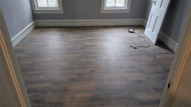 empty room featuring dark wood-type flooring