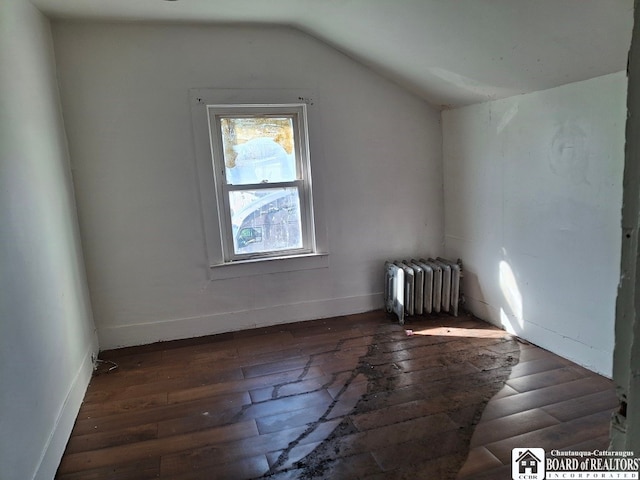 bonus room featuring radiator heating unit, dark hardwood / wood-style floors, and vaulted ceiling