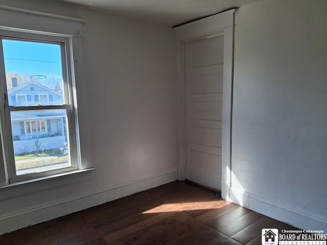 unfurnished room featuring dark hardwood / wood-style floors