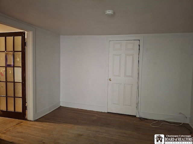 spare room with dark hardwood / wood-style flooring