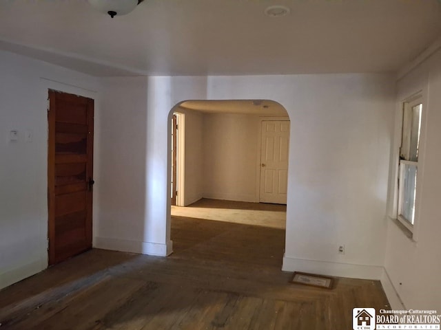 unfurnished room featuring dark wood-type flooring