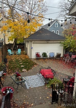 exterior space featuring a patio area, an outbuilding, and a garage