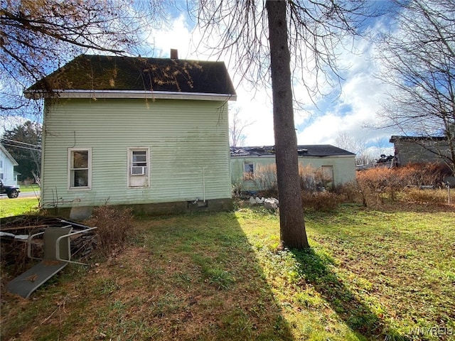 view of side of home featuring a yard