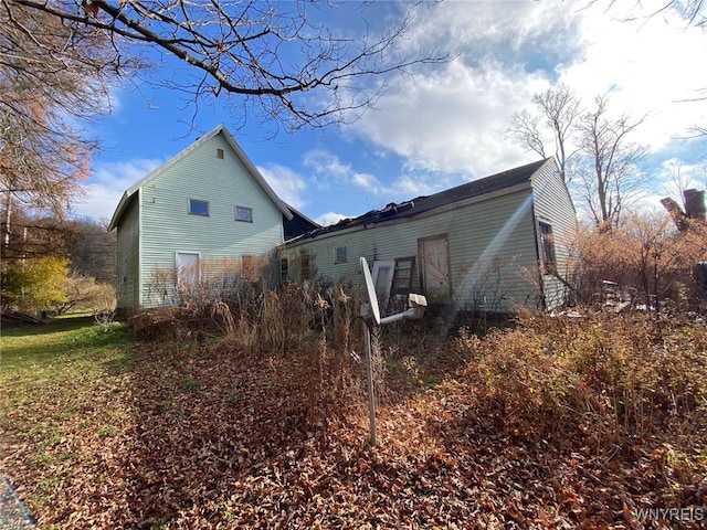 view of side of property with basketball hoop