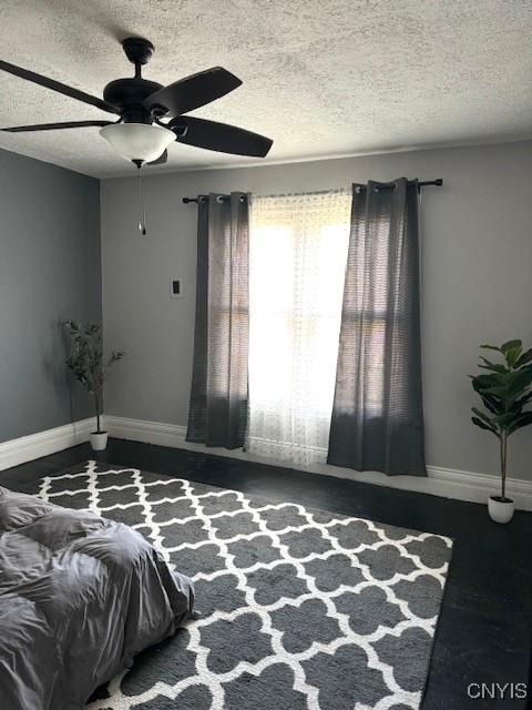 bedroom featuring a textured ceiling and ceiling fan