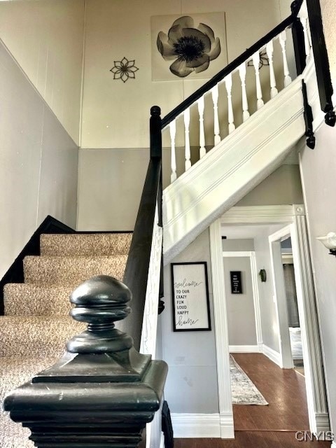 staircase with hardwood / wood-style floors