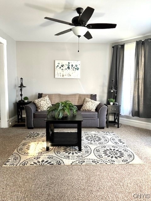 living room with ceiling fan and carpet